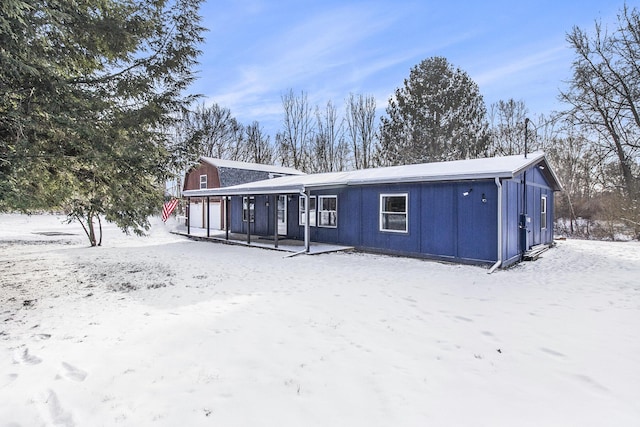 view of snow covered rear of property