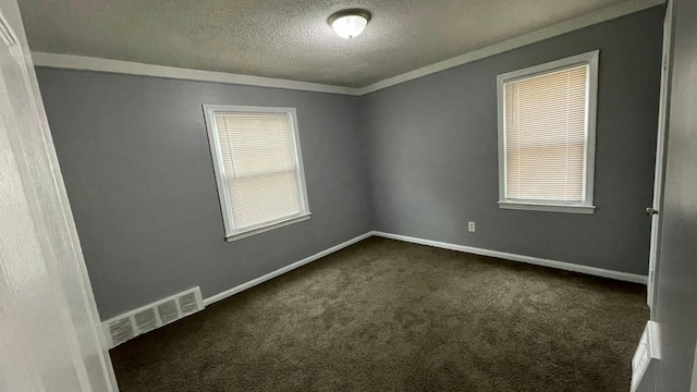 carpeted spare room with a textured ceiling