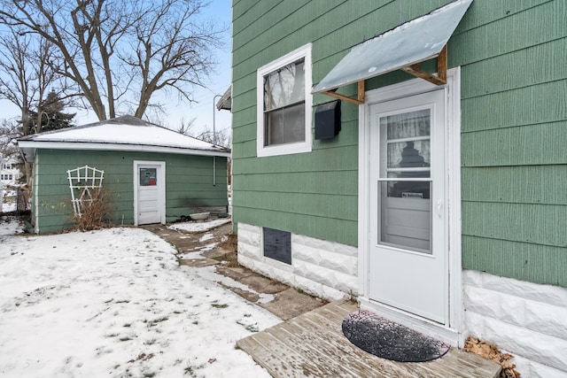 view of snow covered property entrance