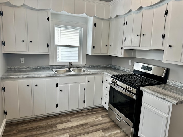 kitchen featuring sink, white cabinets, and stainless steel gas range