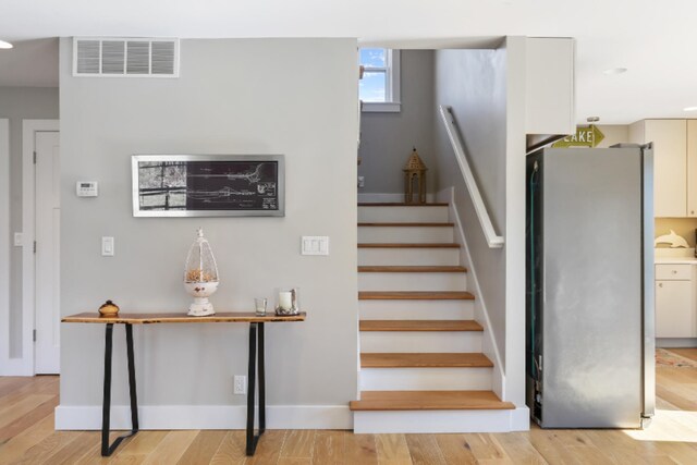 stairway with hardwood / wood-style flooring