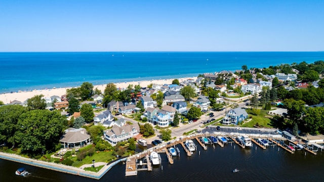 bird's eye view with a water view and a beach view
