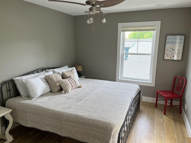 bedroom featuring hardwood / wood-style flooring and ceiling fan