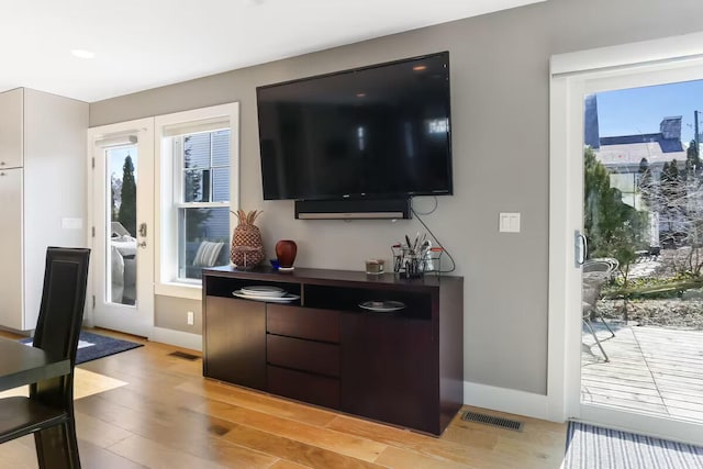 living room with french doors and light hardwood / wood-style floors