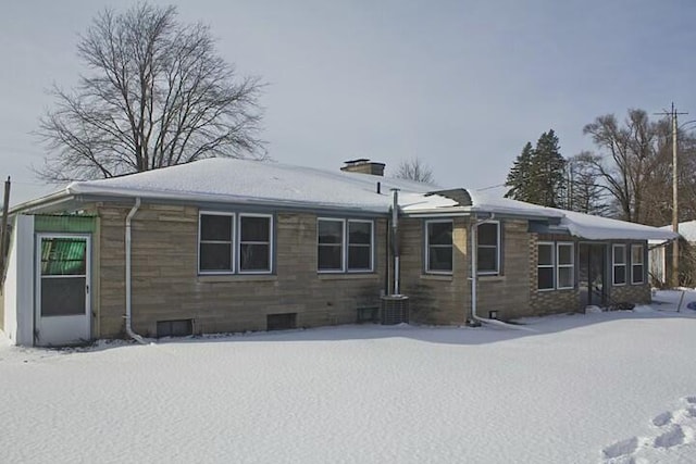 view of snow covered rear of property