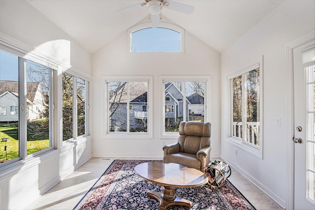 sunroom / solarium featuring ceiling fan, vaulted ceiling, and a healthy amount of sunlight