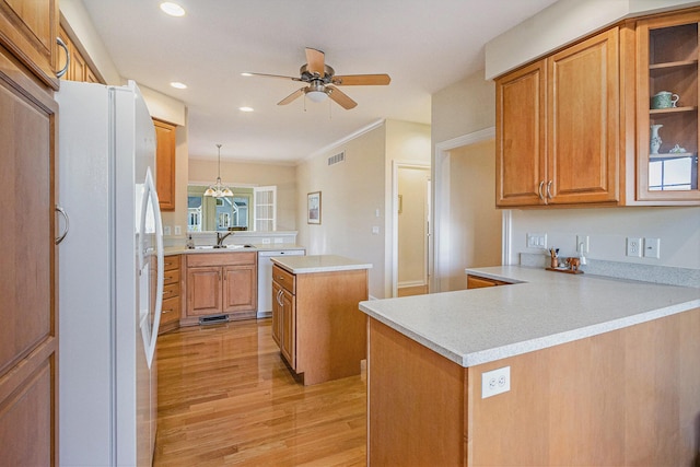 kitchen with a center island, white refrigerator, kitchen peninsula, dishwasher, and pendant lighting