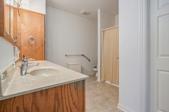 bathroom with vanity, tile patterned floors, and toilet