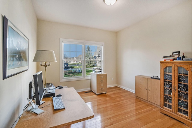 home office with light wood-type flooring