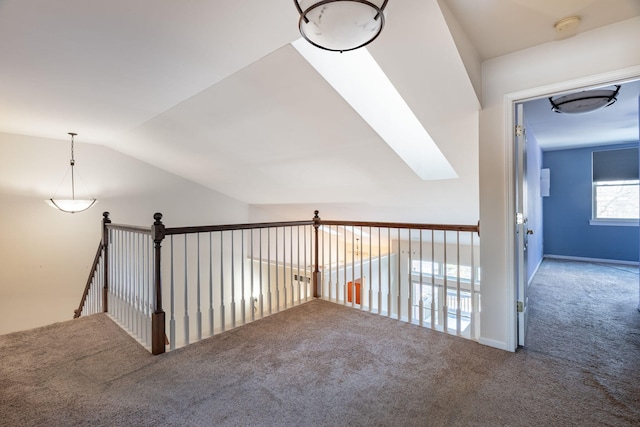 hallway with carpet floors and lofted ceiling