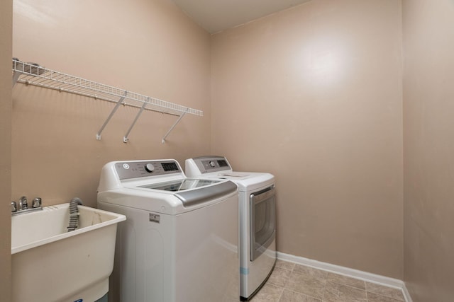 laundry area featuring sink and washer and clothes dryer