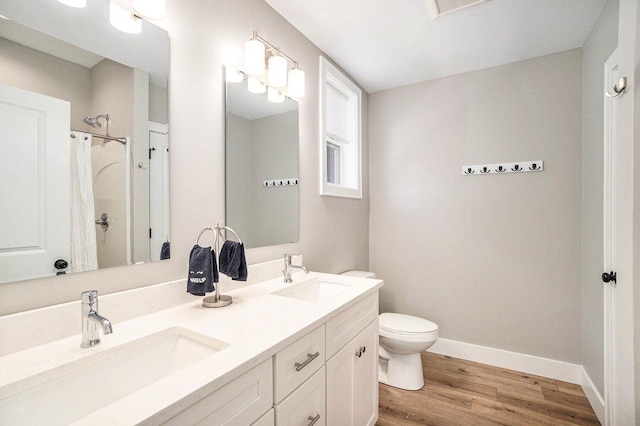 bathroom featuring vanity, toilet, hardwood / wood-style floors, and a shower with curtain