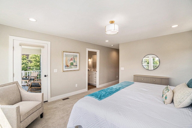 carpeted bedroom featuring access to exterior, multiple windows, and ensuite bath