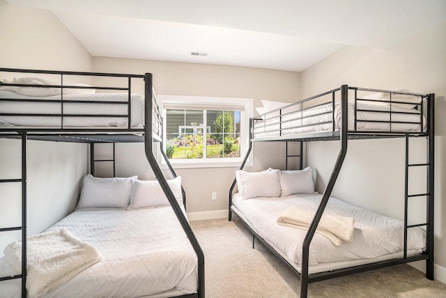 bedroom featuring light colored carpet