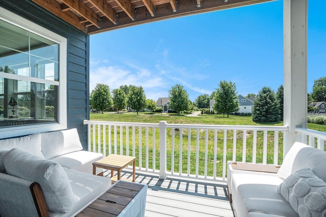 wooden terrace featuring a yard