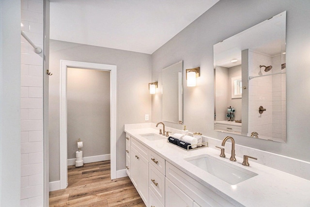 bathroom featuring a shower, hardwood / wood-style floors, and vanity