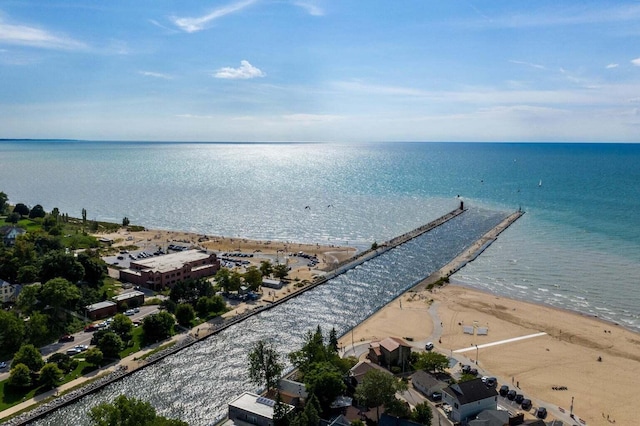 birds eye view of property featuring a water view and a beach view