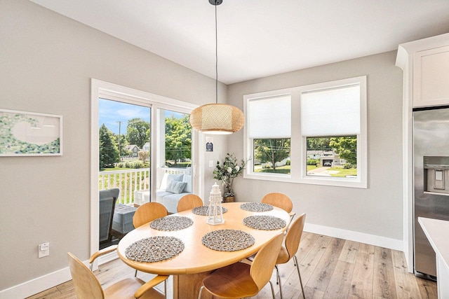 dining space with light hardwood / wood-style floors