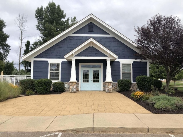 craftsman-style house with french doors