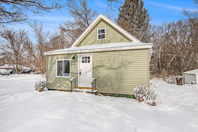 view of snow covered back of property