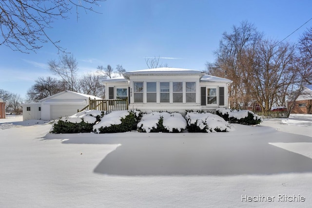 view of front of house featuring a garage and an outdoor structure