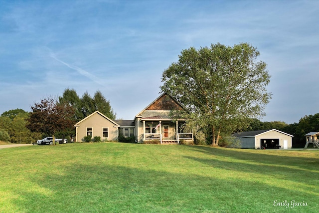 view of front of house with a porch, a garage, and a front lawn