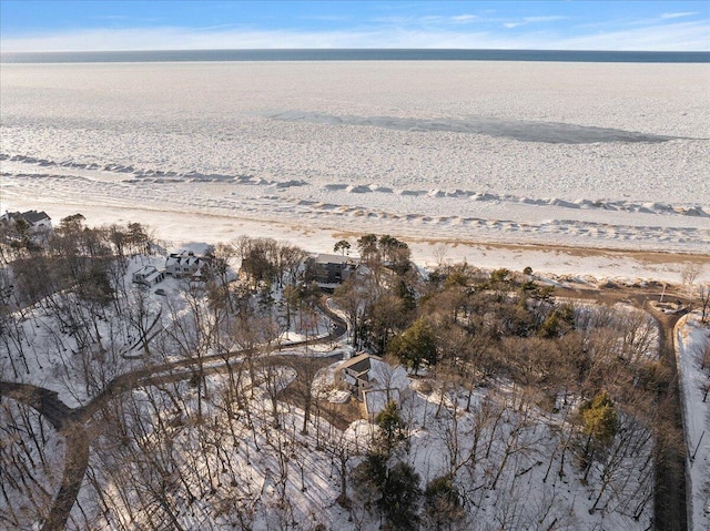 drone / aerial view featuring a water view and a view of the beach