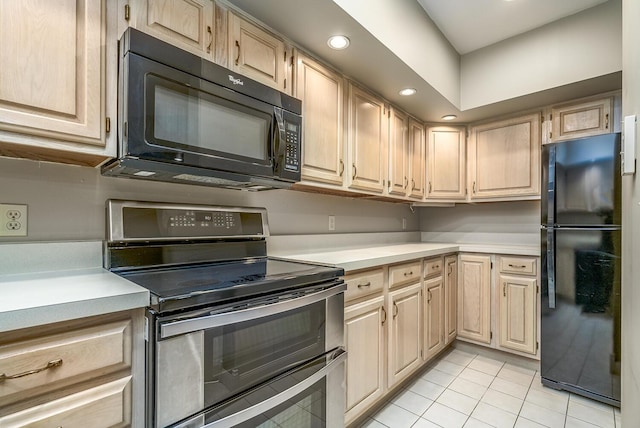 kitchen featuring light brown cabinetry, black appliances, and light tile patterned flooring