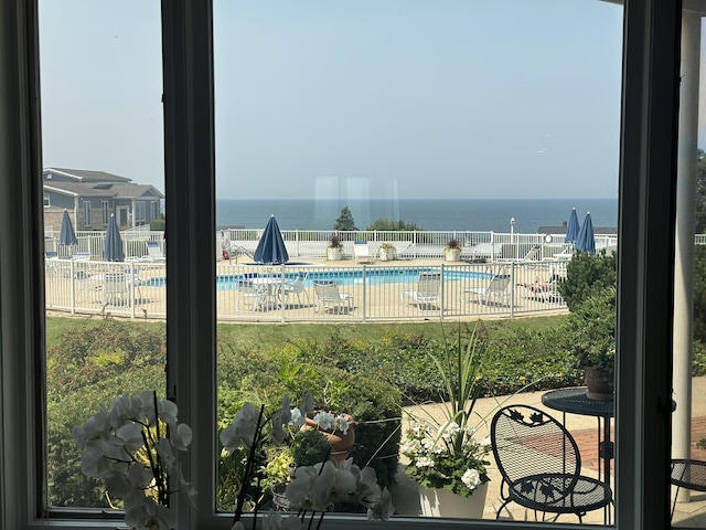 view of swimming pool featuring a water view