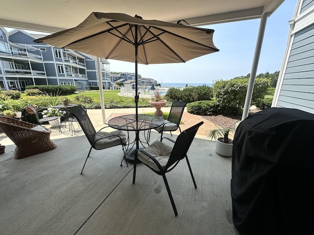 view of patio featuring a water view and a grill