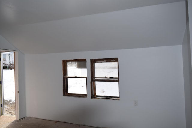 spare room with vaulted ceiling