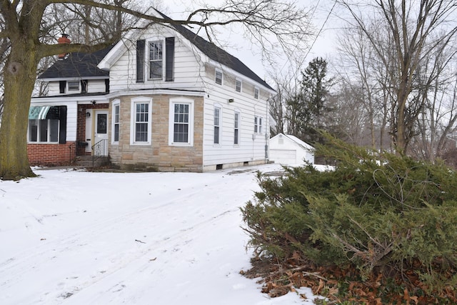 view of front of home with a garage and an outdoor structure