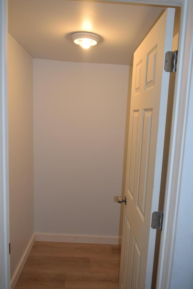 hallway with wood-type flooring