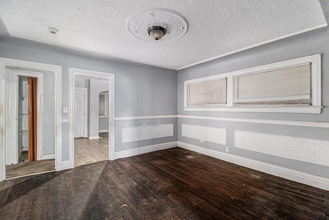 empty room featuring hardwood / wood-style floors and a textured ceiling