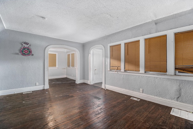 interior space with dark wood-type flooring and a textured ceiling