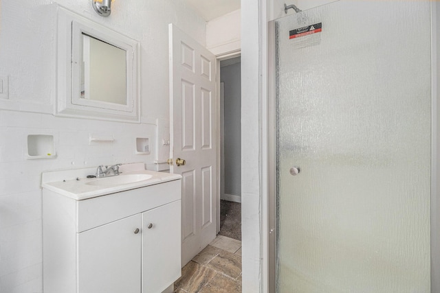 bathroom featuring vanity and an enclosed shower