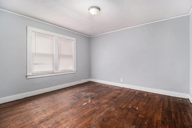 spare room featuring dark hardwood / wood-style flooring, ornamental molding, and a textured ceiling