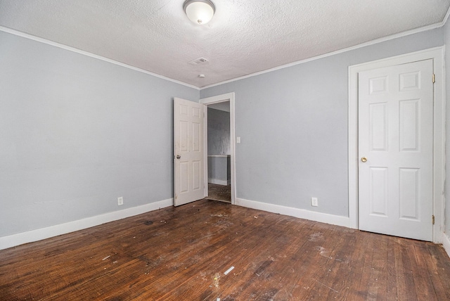 empty room with ornamental molding and dark hardwood / wood-style floors