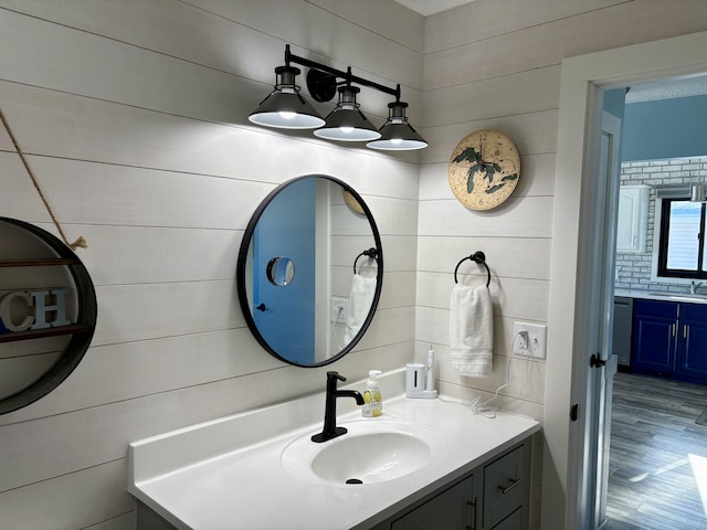 bathroom with wood finished floors and vanity