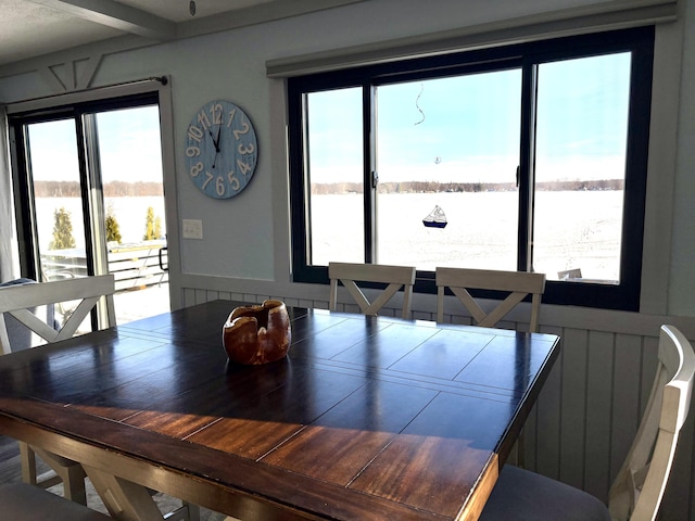 dining space featuring a water view