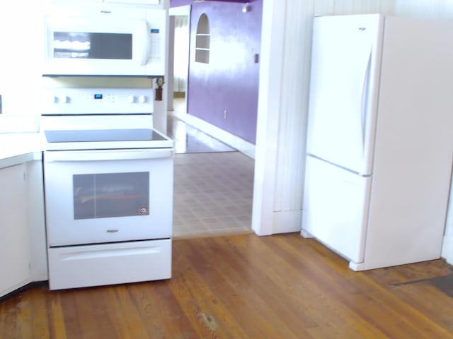 kitchen featuring white appliances and wood-type flooring