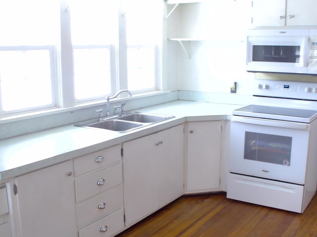 kitchen with white cabinetry, white appliances, dark hardwood / wood-style flooring, and sink