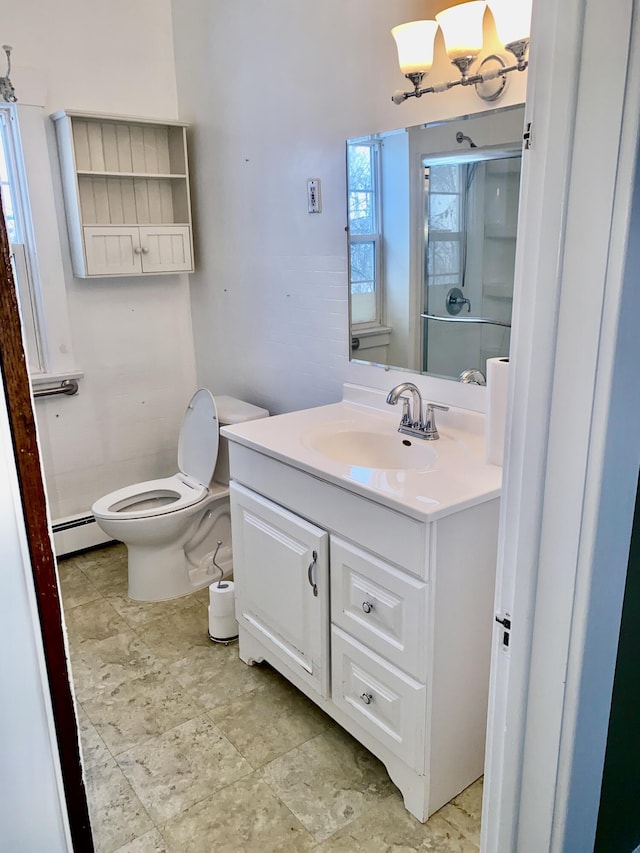 bathroom featuring vanity, an enclosed shower, toilet, and baseboard heating