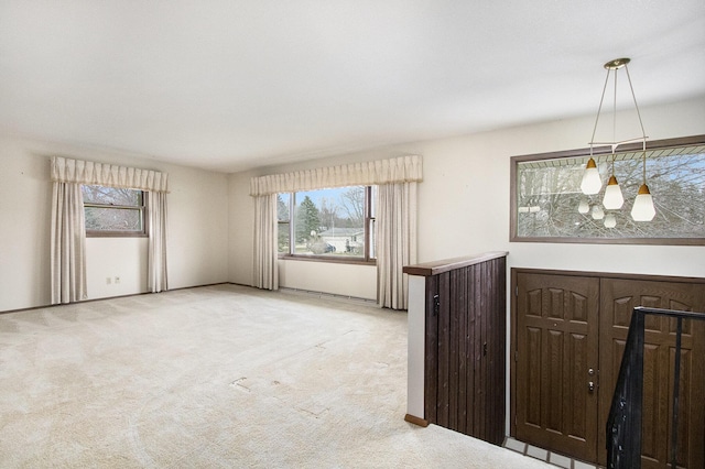 unfurnished room featuring light carpet