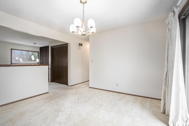 unfurnished room featuring a notable chandelier and light colored carpet