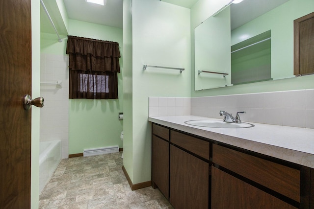 bathroom featuring washtub / shower combination, decorative backsplash, and vanity