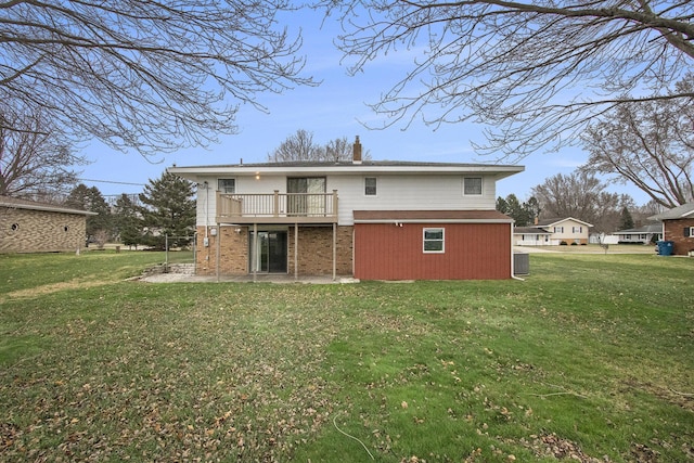 rear view of house featuring a wooden deck, central air condition unit, a lawn, and a patio area