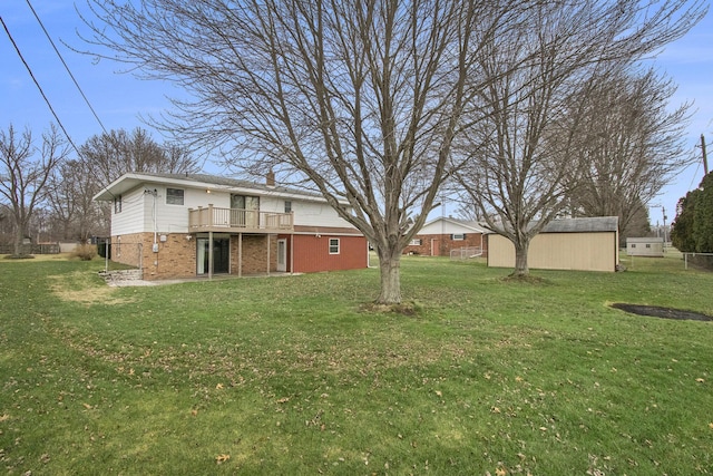 view of yard featuring a deck and a storage shed