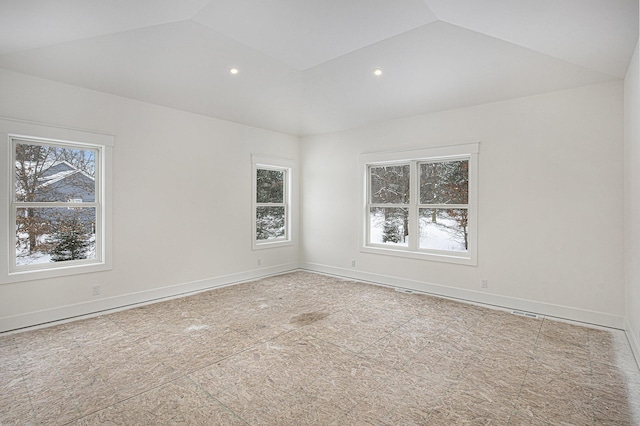 unfurnished room with lofted ceiling