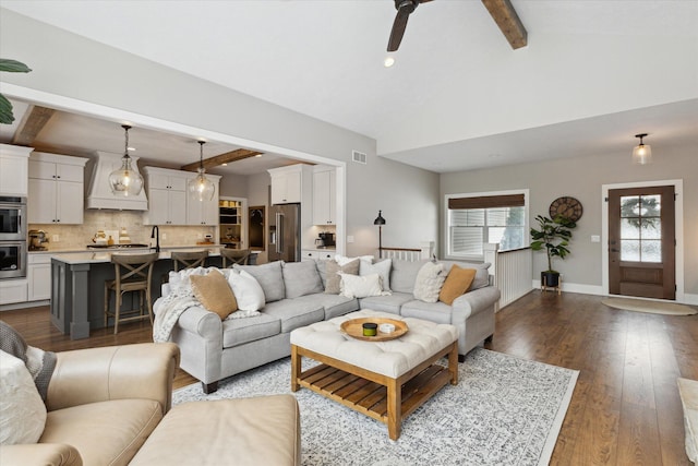 living room with ceiling fan, vaulted ceiling with beams, and dark hardwood / wood-style flooring